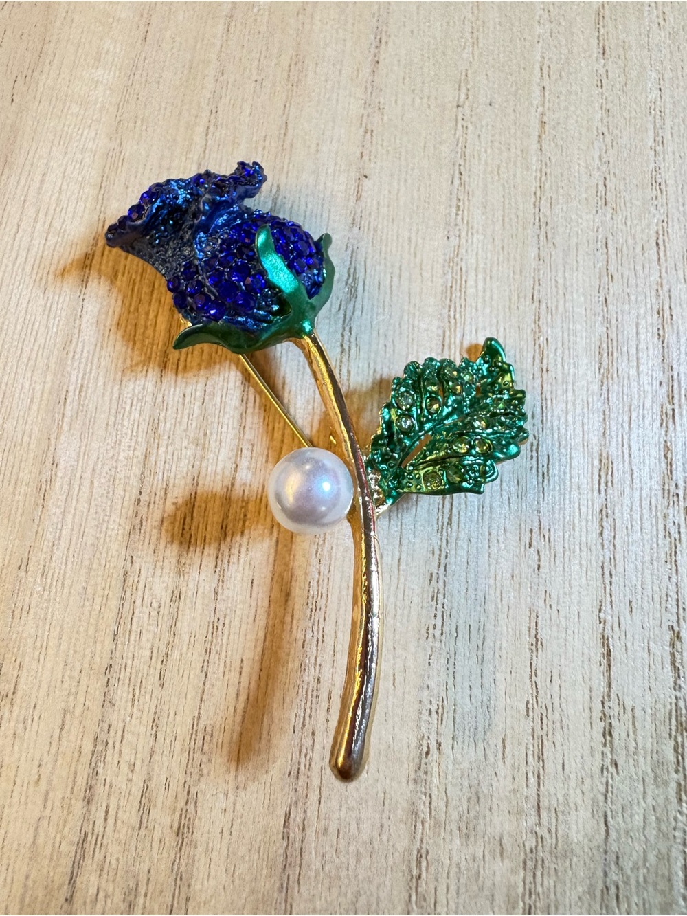 Gold-Tone Blue Crystal Rose Brooch with Green Leaves and Pearl Accent